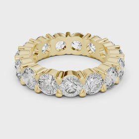 The Stella round lab-grown diamond eternity wedding band in yellow gold — rotating view